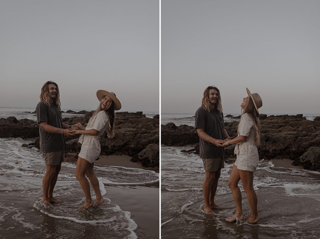 couple holding hands in the water at laguna beach