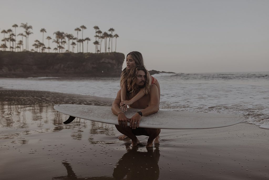 couple holding surfboard on the ocean