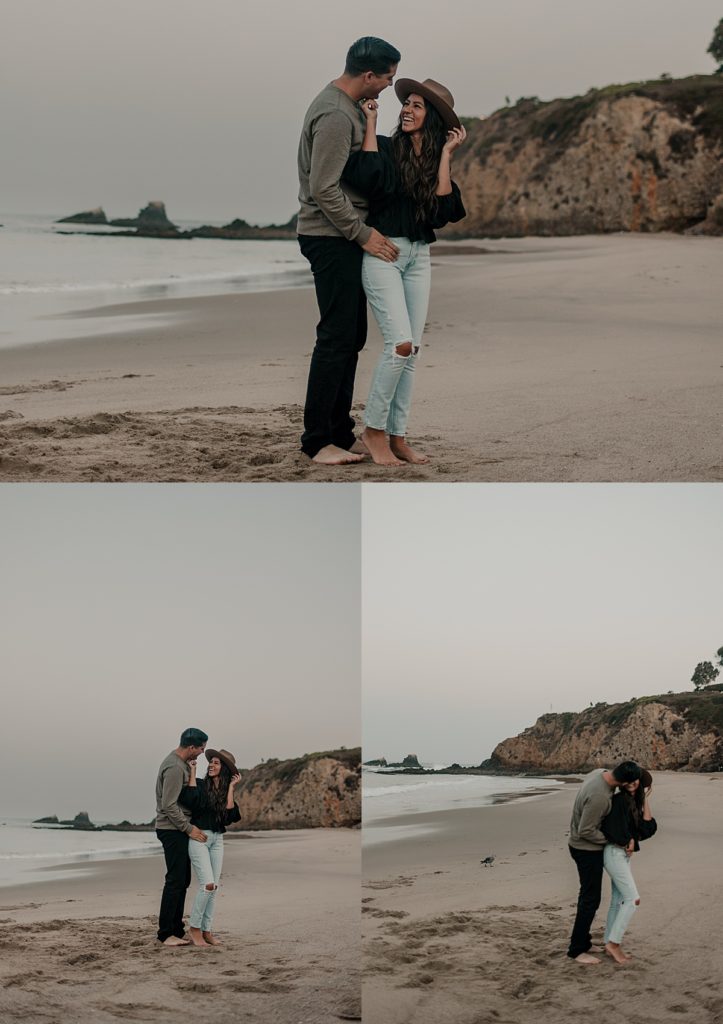 couple standing on sand kissing