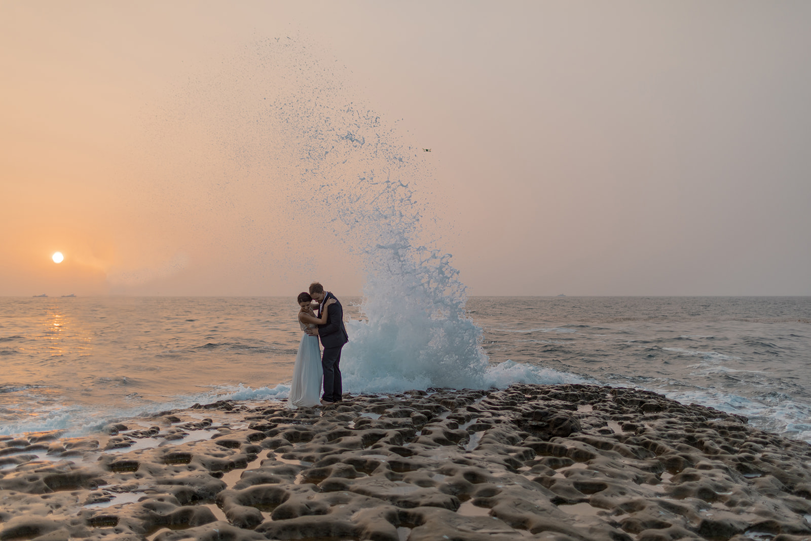 bride and groom kissing on cliffside during beach elopement in san diego 