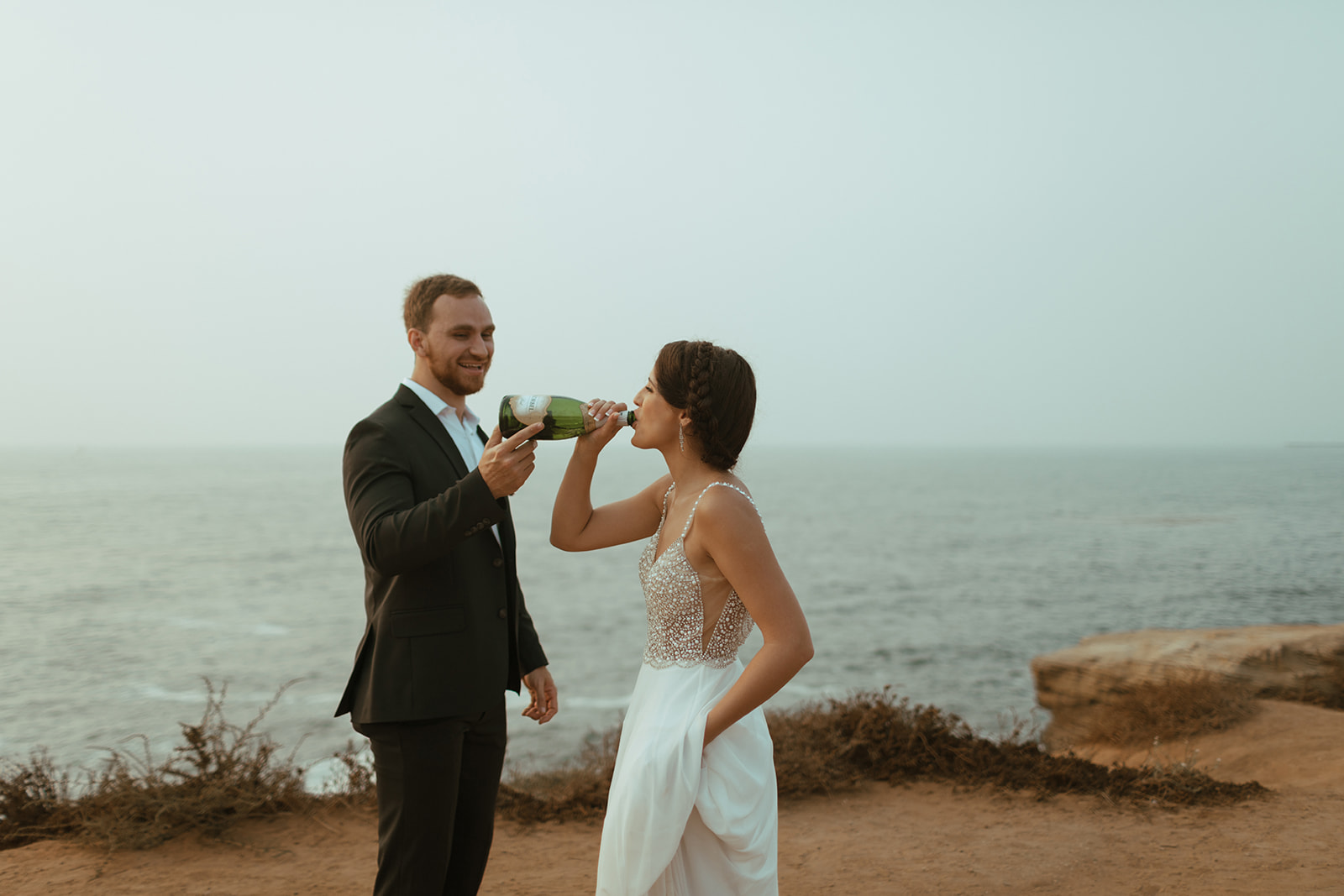 bride and groom at elopement drinking champagne in san diego 