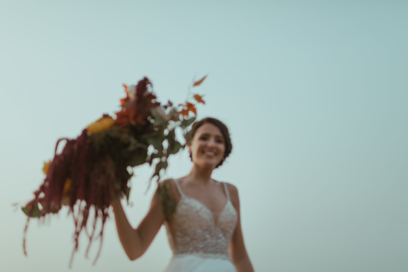 bride at san diego elopement holding her boho wedding flowers