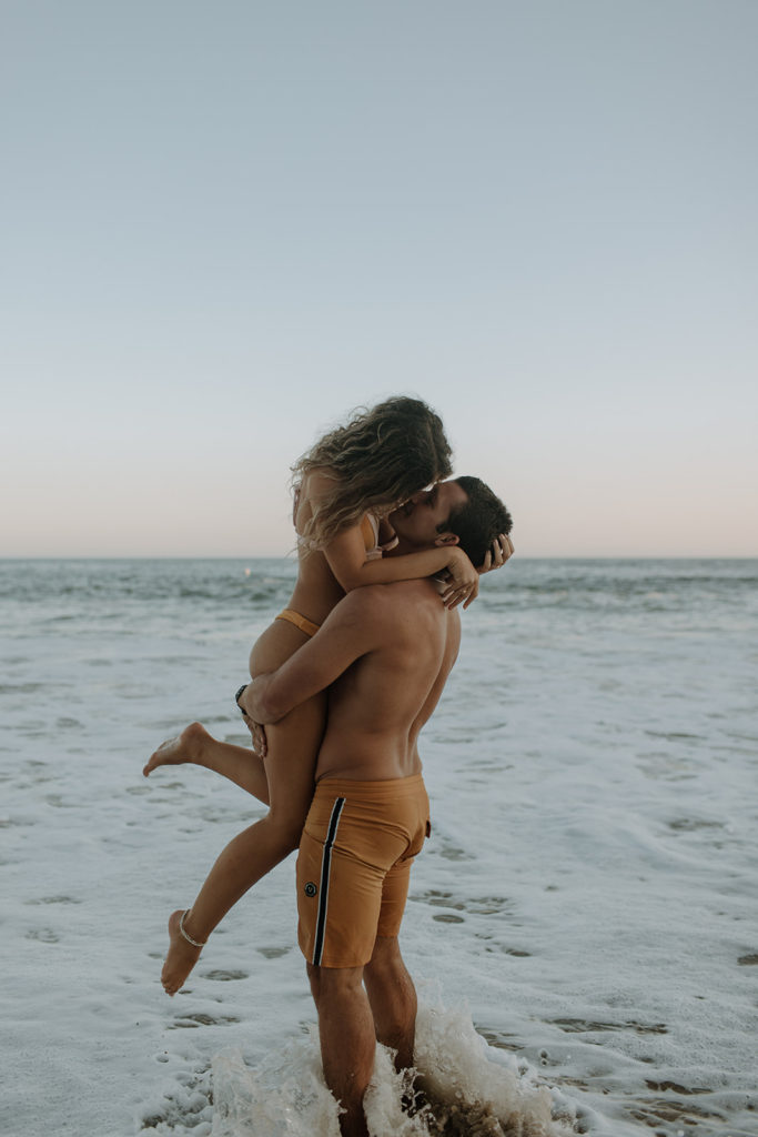 playful couple on beach