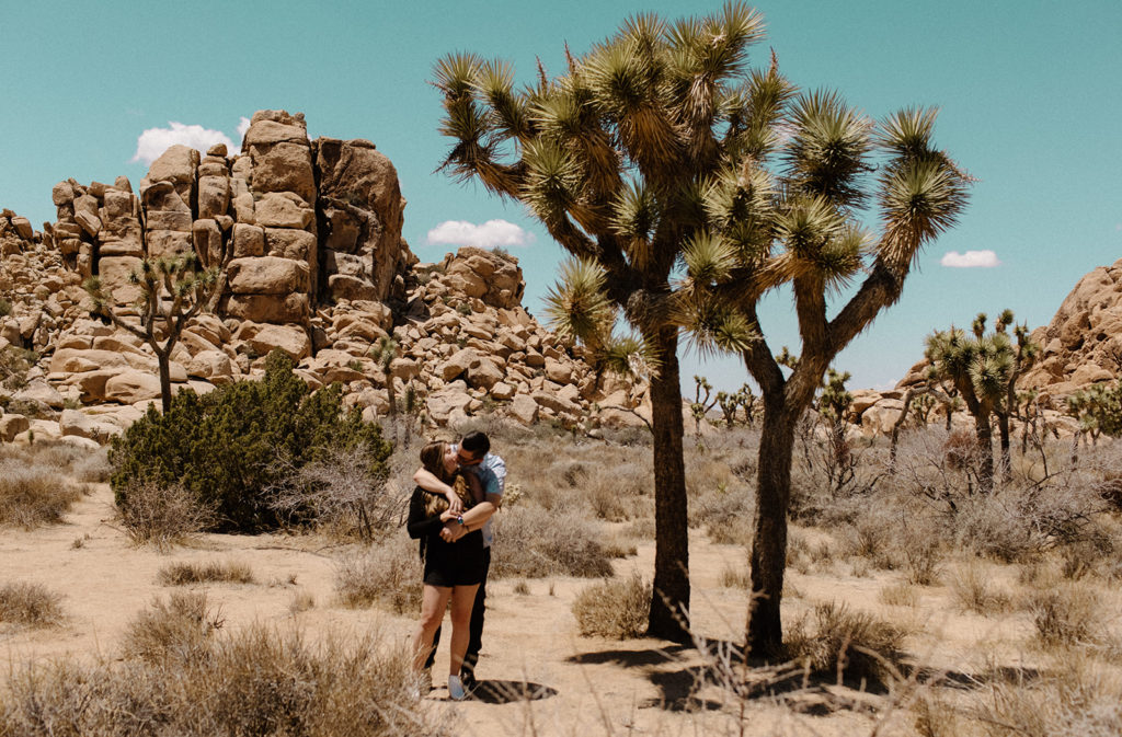 couple hugging at desert engagement photoshoot