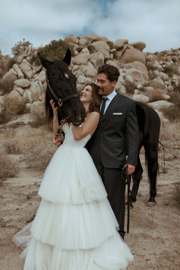 bride and groom with horse during styled photo shoots