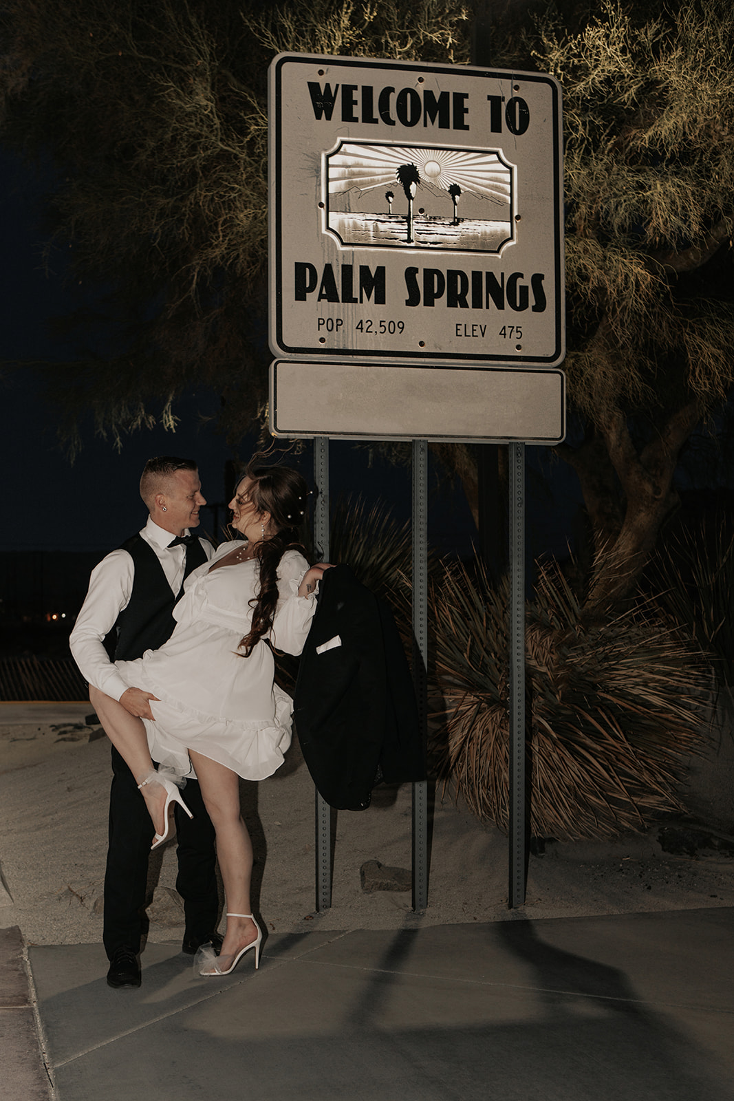 husband holding wifes leg during palm springs elopement 