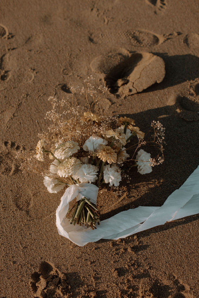 Southern California Beach Elopement at Laguna Beach with beautiful beach sand and boho themed wedding flowers